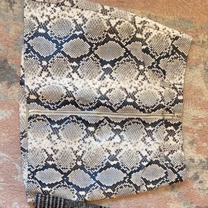 Snake skin leather skirt with ring zipper.